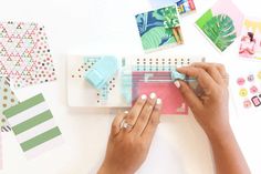 a woman is making crafts with her hands and some other things on the table next to her