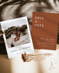 an open book with a photo on it next to a couple's wedding card