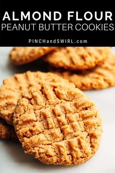 three peanut butter cookies stacked on top of each other with text overlay reading almond flour peanut butter cookies