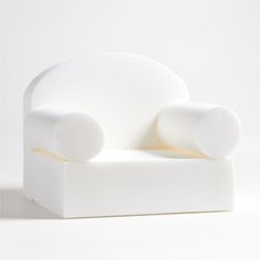 a white chair sitting on top of a white floor