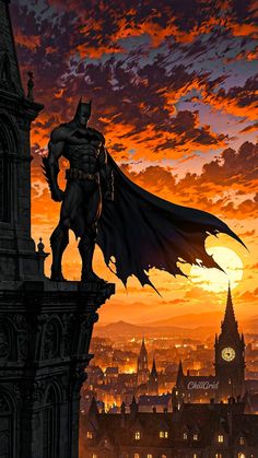 a batman statue on top of a building with the sun setting in the back ground