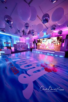 the dance floor is lit up with balloons