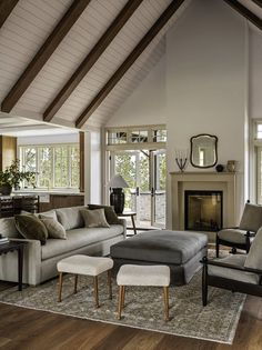 a living room filled with furniture and a fire place in the middle of a room