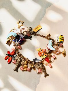 Adorable goldtone bracelet adorned with enameled charms of cats, birds, butterflies, bees. Also has goldtone charms, colorful glass beads. Original stickers. Great for cat lovers. Bracelet measures 8". Lobster clasp. Pencil Bracelet, Lovers Bracelet, Bracelet Vintage, Girly Jewelry, Austin Tx, Charm Bracelets, Bling Bling, Shopping Cart, Colored Glass