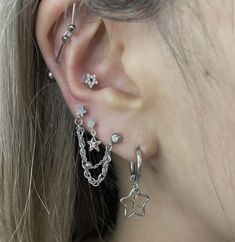 a close up of a person's ear with three different types of piercings