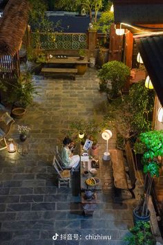 an overhead view of a person sitting on a bench in the middle of a courtyard