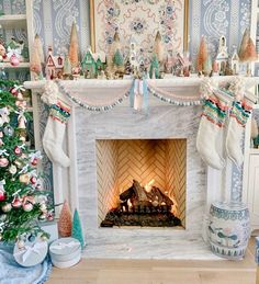 a fireplace decorated with christmas stockings and decorations