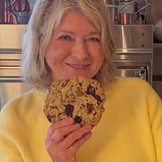 a woman holding a cookie up to her face