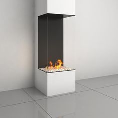 a modern fire place in the middle of a room with white walls and flooring