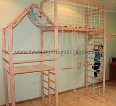 a child standing in front of a loft bed