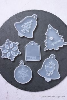 christmas ornament cookie cutters are shown on a slate platter with snowflakes and ornaments