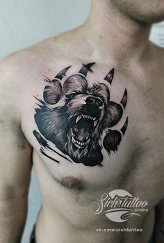 a man's chest with a bear tattoo on it and an arrow in the middle