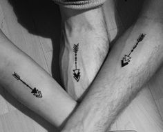 two people with matching tattoos on their arms