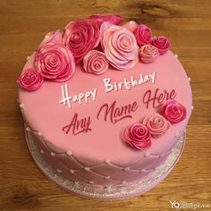 a pink birthday cake with roses on it