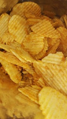 a bowl filled with potato chips sitting on top of a table