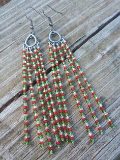 These earrings feature traditional Christmas colored seed beads Holiday Dangle Beaded Earrings, Christmas Colorful Beaded Dangle Earrings, Christmas Dangling Bead Earrings, Christmas Festive Beaded Dangling Earrings, Christmas Dangle Earrings With Beads, Christmas Dangle Earrings With Dangling Beads, Christmas Dangle Beaded Earrings With Colorful Beads, Green Beaded Earrings For Holidays, Christmas Beaded Dangle Earrings With Ear Wire