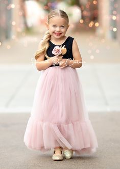 Dress your little one in the enchanting Mauve & Black Tulle Flower Girl Dress to make her feel like a princess at weddings and special occasions! This stunning dress features a delicate black lace bodice combined with a whimsical long flowing mauve ruffle tulle skirt, creating a perfect harmony between elegance and charm. Perfect for dreamy, romantic, fairytale, or classic wedding themes, this dress will surely make your little girl stand out. For an extra touch of magic, pair it with matching b Elegant Bridesmaid Tutu Dress With Lace Trim, Fitted Gown With Lace Bodice For Dress-up, Lace Princess Dress With Fitted Bodice For Bridesmaids, Bridesmaid Princess Dress With Lace Bodice, Sleeveless Bridesmaid Princess Dress With Lace Trim, Elegant Pink Tutu Dress For Garden Party, Elegant Tulle Princess Dress For Garden Party, Bridesmaid Tutu Dress With Fitted Bodice And Tulle Skirt, Spring Gown With Lace Bodice In Tulle