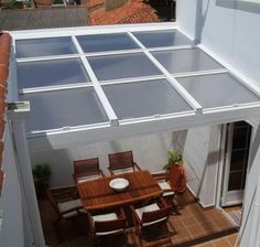 an overhead view of a patio with table and chairs on the roof top terrace area