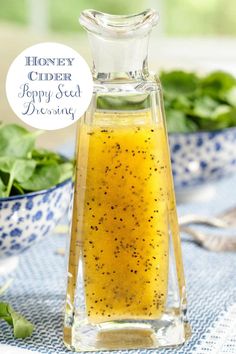 a glass bottle filled with honey and poppy seed dressing