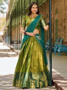 Introducing an exquisite masterpiece of traditional Indian attire: the green kanchipuram silk half saree lehenga with intricate zari weaving work. This lehenga is a stunning blend of rich heritage and contemporary style, crafted meticulously to enhance your elegance at any event. The fabric’s luxurious texture and the grandeur of the zari work reflect the impeccable craftsmanship of kanchipuram silk, known for its unparalleled quality and beauty.
Accompanying this majestic lehenga is a green kan South Indian Style Half Saree, Mehendi Outfits For Bride 2024, Traditional Dresses From Saree, Poses On Half Saree, South Indian Dress Outfits, Off Saree Models, Blouse For Half Saree, South Indian Lehenga Half Saree, Half Saree For Engagement