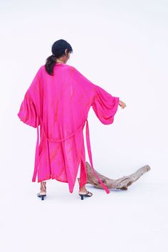 An impressive statement piece, the Miko - Fuchsia Kimono Robe & Jacket is as luxurious as it is versatile. With its chic Fuschia hue, this sophisticated piece can easily elevate any look. Ideal for a sophisticated night out, wear this jacket over a jumpsuit or little black dress and heels. Features: Soft feel Lightweight feel Very comfortable Handmade Oversized fit Puffy sleeves Oversized -One size all fit Removable waist tie closure with loops Side slits at hem No pockets Hand wash in cold wate Pink Kimono For Fall Vacation, Pink Fall Vacation Kimono, Pink Party Kimono, Fitted Pink Summer Kimono, Chic Pink Beach Kimono, Pink Long Sleeve Kimono For Party, Pink Spring Party Kimono, Spring Party Pink Kimono, Fitted Pink Kimono