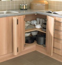 an open cabinet in the corner of a kitchen