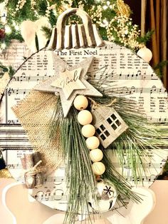 a christmas ornament on top of a plate with pine branches and ornaments around it