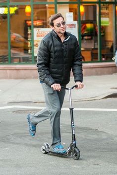 a man is riding an electric scooter on the street