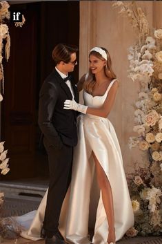 a man in a tuxedo standing next to a woman in a wedding dress