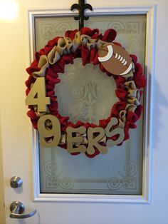 a football wreath with the number forty nine on it hanging in front of a door