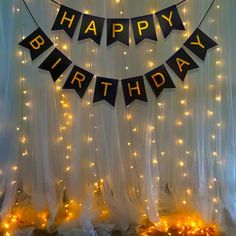 a happy birthday banner with lights on it