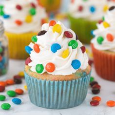 cupcakes with white frosting and colorful candies