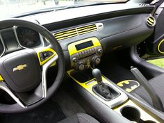 the interior of a car with yellow and black trim