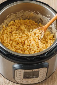 macaroni and cheese is being stirred in the instant pot