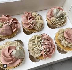 six cupcakes are decorated with pink and white icing