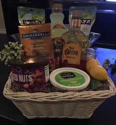 a basket filled with drinks and snacks on top of a table