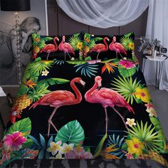 two flamingos and tropical leaves on a black background