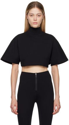 Cotton ribbed jersey T-shirt. · Mock neck · Cropped hem · Saddle shoulders · Five press-stud placket at back collar Supplier color: Noir alaia Black High Neck Top For Streetwear, Fall Athleisure Tops With Short Sleeves, Funnel Neck Athleisure Tops For Streetwear, Athleisure Top With Funnel Neck And Ribbed Collar, High Neck Cotton Top With Ribbed Collar, Athleisure Funnel Neck Top With Ribbed Collar, Athleisure Funnel Neck Top For Streetwear, Black High Neck Athleisure Top, Athleisure Turtleneck Top