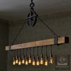 a wooden beam with six light bulbs hanging from it