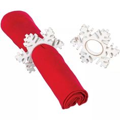 a red napkin with white snowflakes on it next to an orange napkin holder