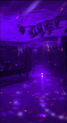 a room with purple lights and disco balls