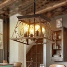 a chandelier hanging from the ceiling in a room with wooden chairs and tables