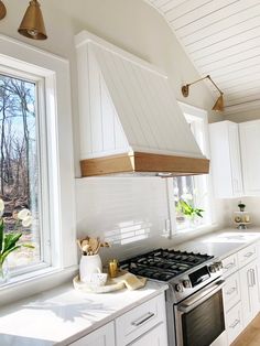 a kitchen with white cabinets and an oven