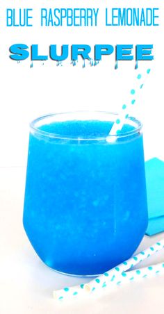 blue raspberry lemonade slurpee is in a glass with straws