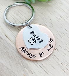 a keychain with a dog's paw and heart on it