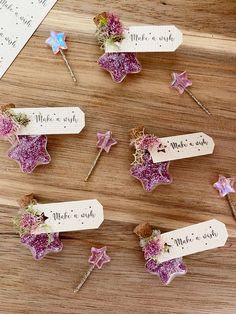 six small pink flowers are placed on top of each other with name tags attached to them