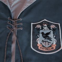 the ravenclaw crest is attached to a blue jacket with laces on it