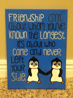 a blue sign with two penguins holding hands