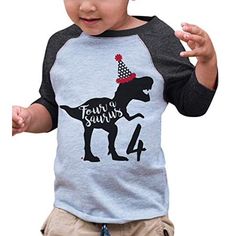 a toddler wearing a birthday hat and t - shirt