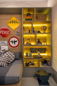 a bed sitting in a bedroom next to a shelf filled with books and other items